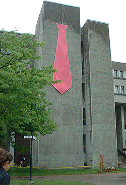 [Pink tie against concrete]