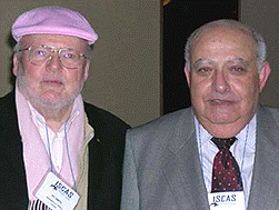 [One in pink hat, one in gray suit]