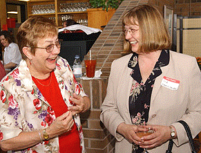 [Two women, bar in background]