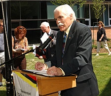 [Leaning on lectern in the open air, Johnston in background]