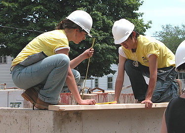 [Two kneeling, in yellow T-shirts]