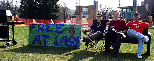 [Barbecue, sofa, sign: 'Free at last']