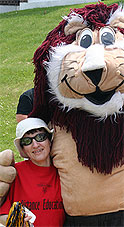 [Little staff member with big stuffed lion]