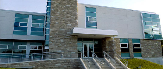 [Two-storey structure with blue window panels]