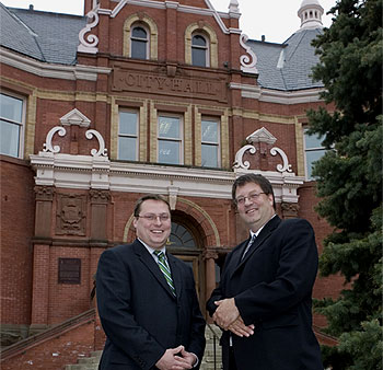 [On steps of brick city hall]