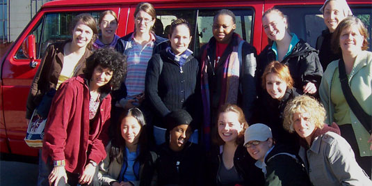 [Group of travellers in front of van]