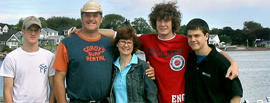 [Seascape in background, family in foreground]