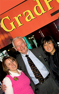 [Three happy faces in front of GradFest banner]