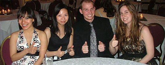 [Three girls and a guy at cabaret table]