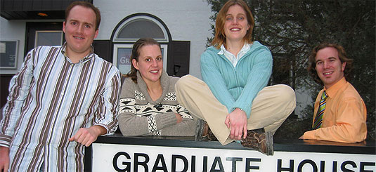 [Faces around Graduate House sign]