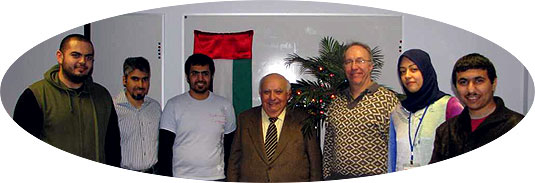 [In front of UAE flag and Christmas greenery]