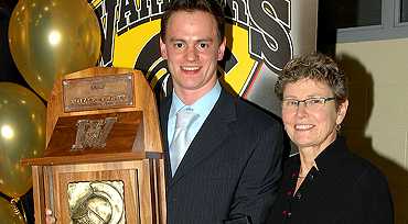 [Chernukhin and Judy McCrae with trophy]