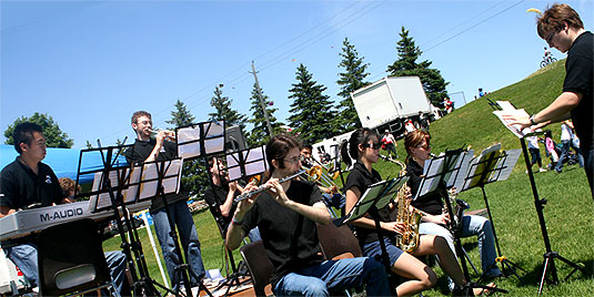 [Playing against green grass and blue sky]