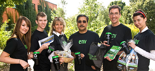 [Black T-shirts, background of greenery]