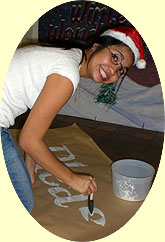 [Santa hat as she works on poster]
