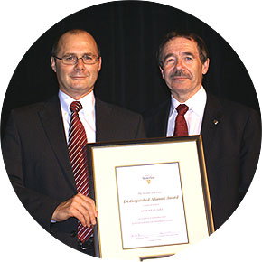 [Both with red ties, posing with certificate]