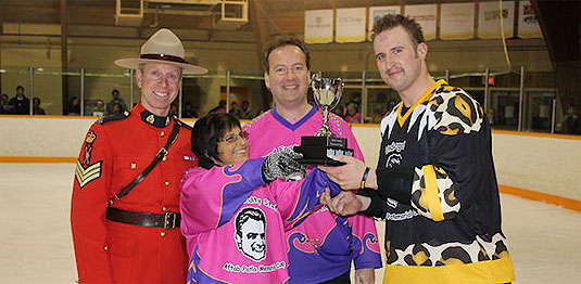 [A mountie and two players in loud uniforms]