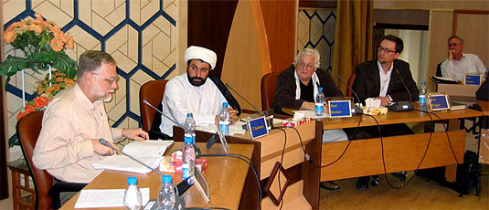 [Western and Islamic dress at seminar table]