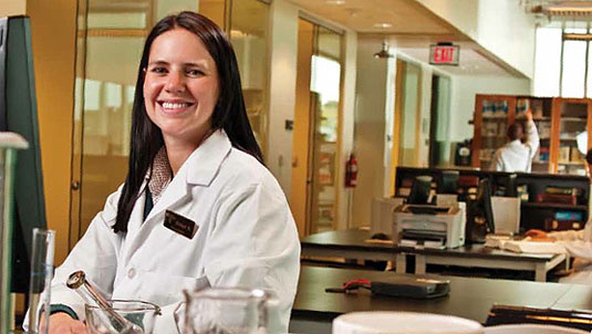 [White coat; posing in professional practice lab in Pharmacy building]