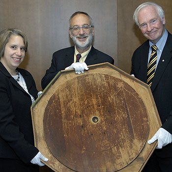 [Holding crokinole board with white gloves]