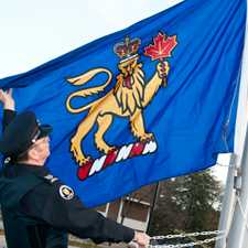 [Police officer raising flag]