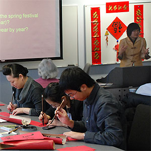 [Calligraphy with brushes and red paper]