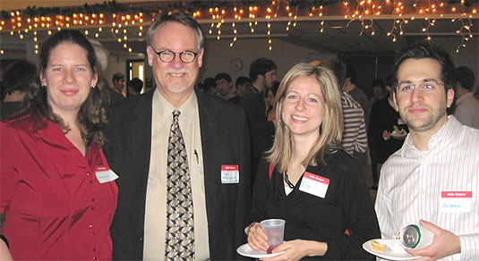 [Four happy people with name tags]