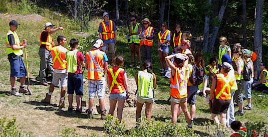 [Students in fluorescent vests]