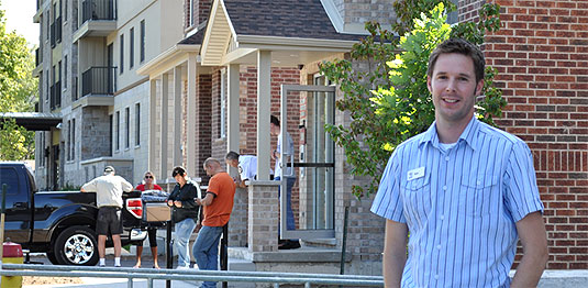 [King, in front of local apartment building]