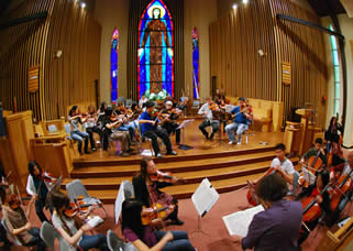 The orchestra rehearses.