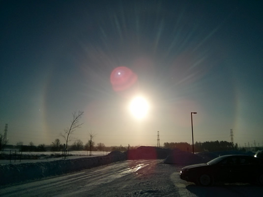 Sundogs surround the sun.