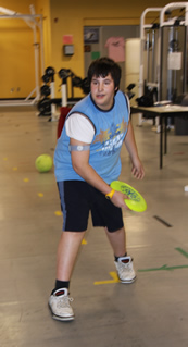 A teen throws a frisbee.