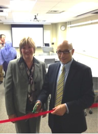 Donna Ellis and Mario Coniglio cut the red ribbon.