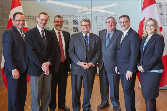 MP Harold Albrecht, Raymond Laflamme, Feridun Hamdullahpur, The Honourable Ed Holder, MP, Vice-President, University Research George Dixon, Peter Braid MP, and Marian Meinen.