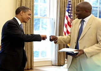 President Barack Obama fist-bumps Reggie Love.