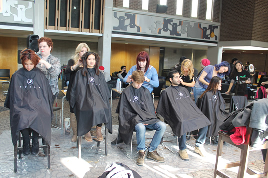 Several students receive haircuts.