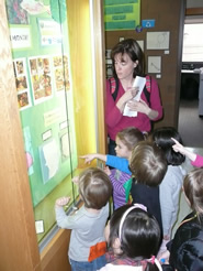 Preschoolers show off their artwork on a tour of the third floor of the PAS.