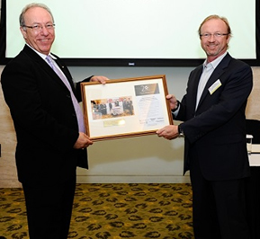 Colin Beaton and Peter Douglas pose with a plaque.