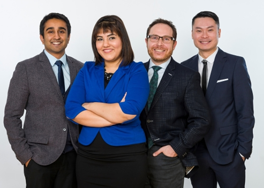 Four Master of Public Service students stand together.