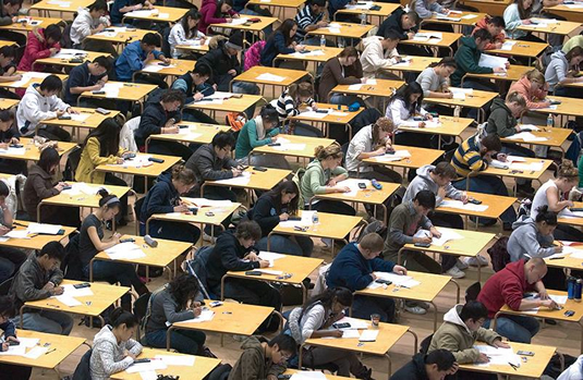 Students writing exams in the Physical Activities Complex.