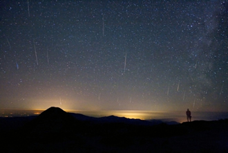 Meteors streak across the night sky.