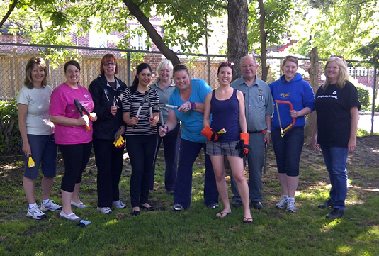 Waterloo United Way volunteers pose with their yard tools.