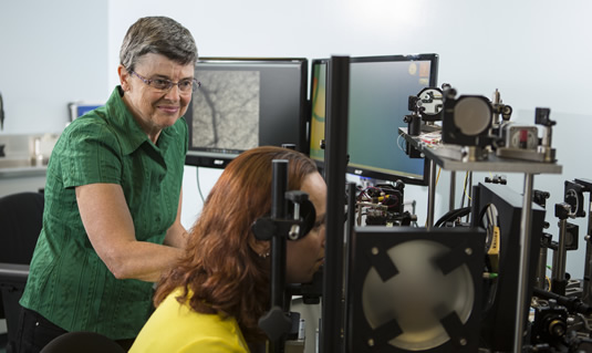 Professor Melanie Campbell and a research associate demonstrate detection equipment.