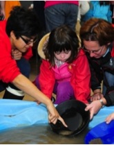 Children do some science at the rock show.