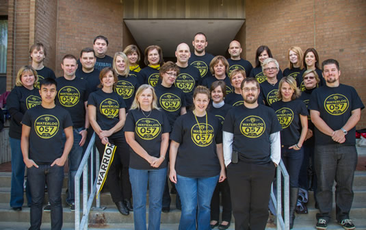 Members of the University Relations department pose on the steps of Needles Hall.