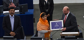 Ziauddin Yousafzai stands next to his daughter Malala as she receives the Nobel Peace Prize.