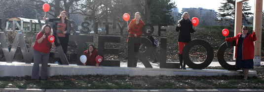 The United Way campaign working group poses with the uWaterloo sign.