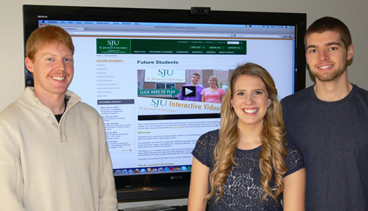 Jay Smith, Jen Gooderham and Mike Sawka pose with the video tour on screen.