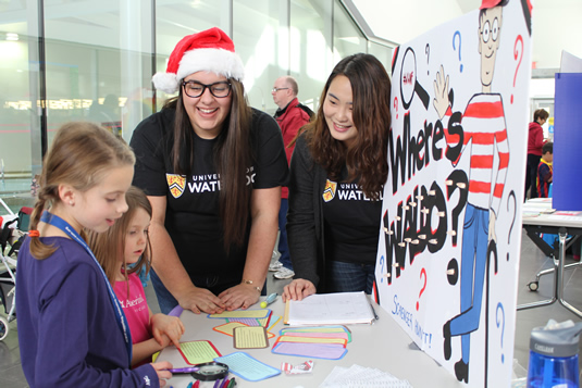 Amanda Vos (left) and Yoonjung Lee (right) interact with children at Waterloo West NeighbourFest.