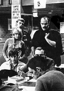 Students look on as Paul Gerster conducts business in his transplanted office in the Great Hall, post-liberation.